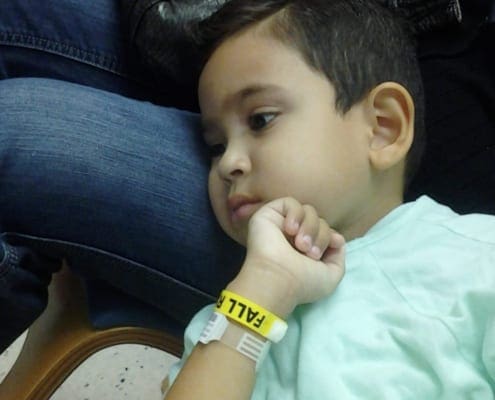 Mateo Grattone while he was sick laying his head on his Moms lap