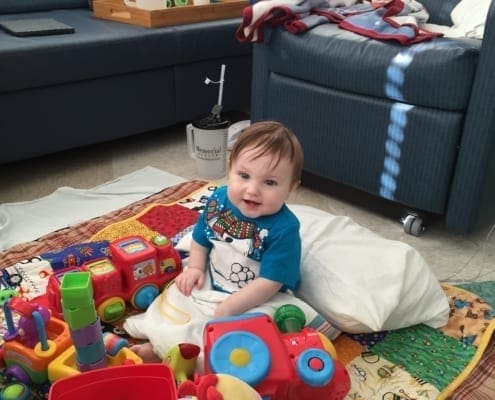 Another picture of Jonathan in his hospital rooming smiling and playing with his toys